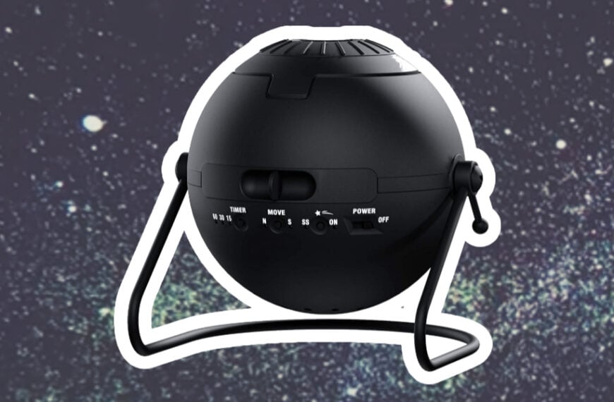 A black spherical star projector with control buttons sits against a starry background.