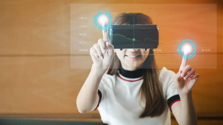 A young woman is holding a virtual reality headset.