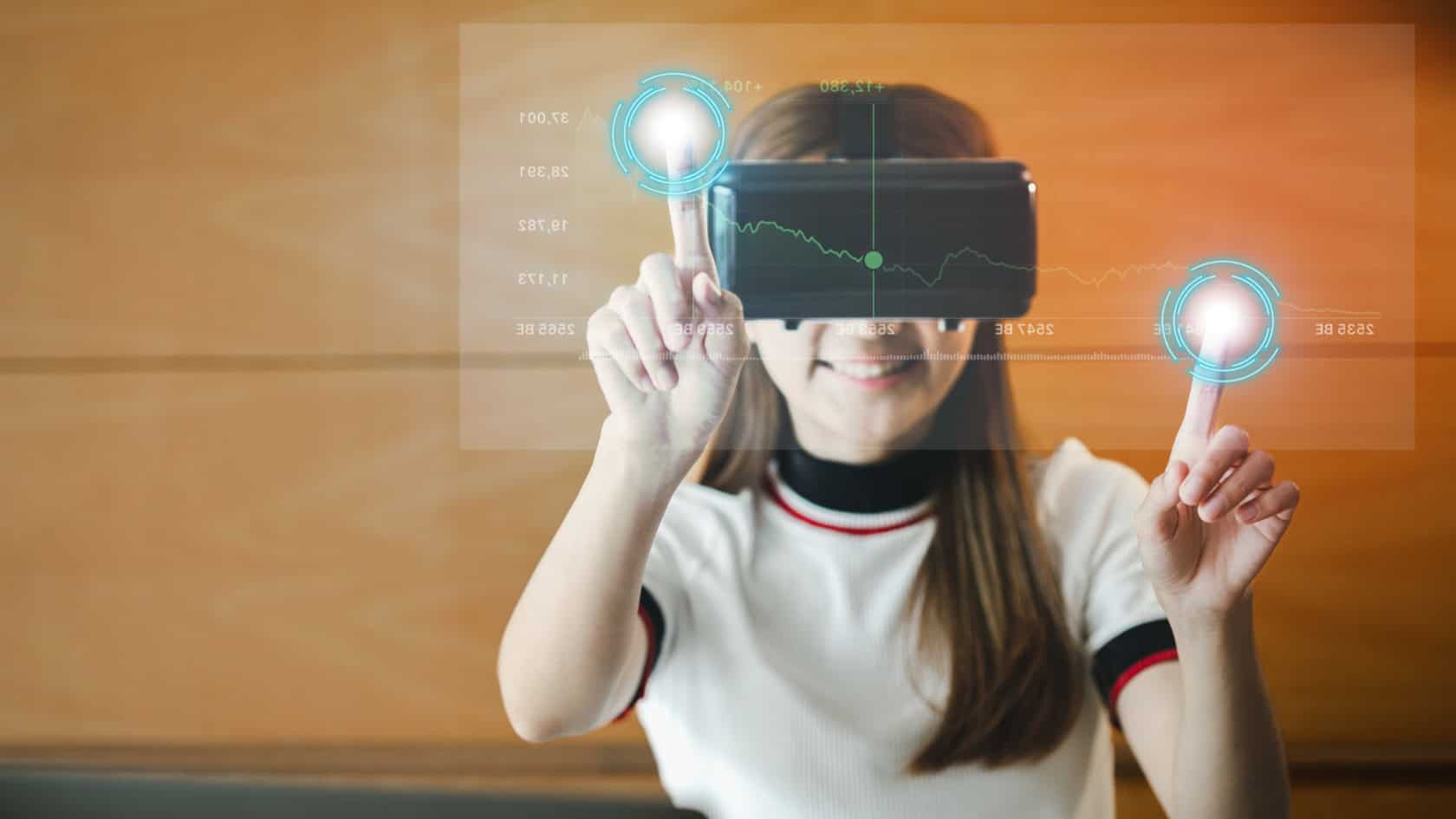 A young woman is holding a virtual reality headset.