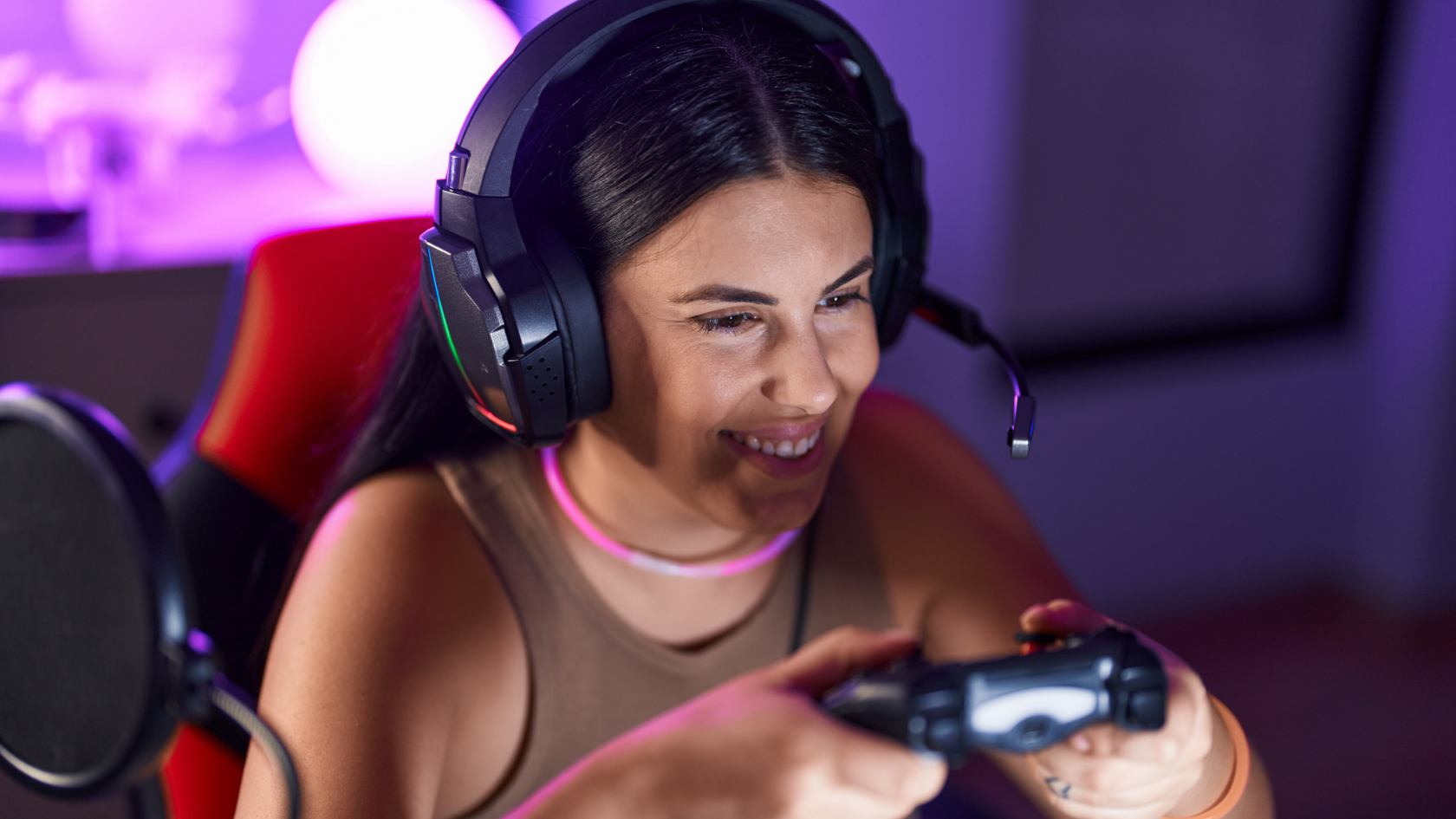 A woman wearing headphones is playing a video game.