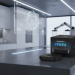 A smart home device and its box labeled "Homey Pro mini" are displayed on a modern kitchen island with digital screens and a robotic arm in the background.