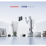 A futuristic scene features various smart home devices, a humanoid robot, and gadgets on display under the banner "SwitchBot | CES 2026.