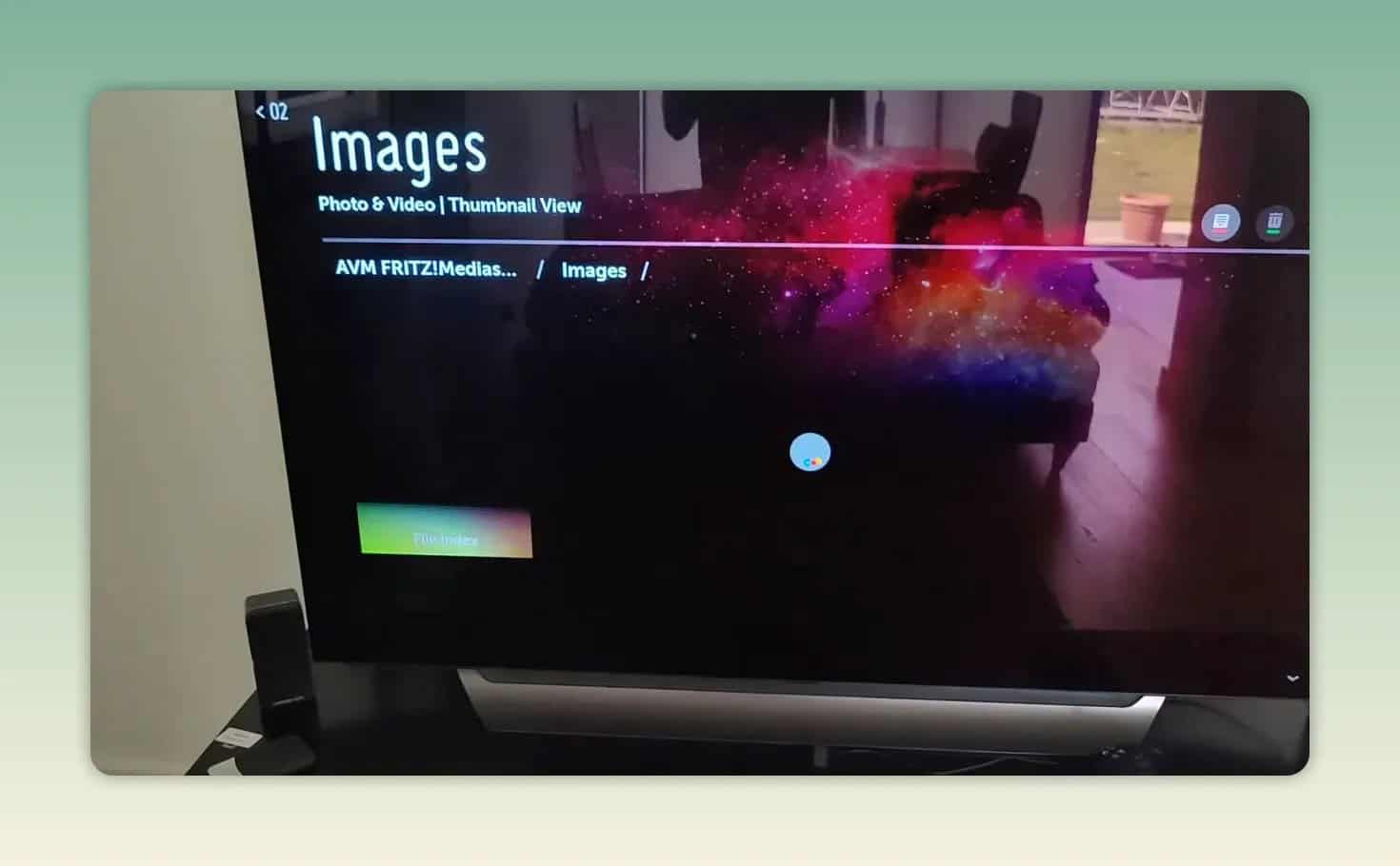 Television displaying a photo of a black cat from a media server